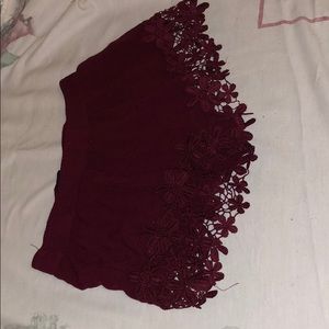 burgundy shorts.